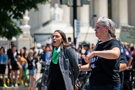 Representative Alexandria Ocasio-Cortez, a Democrat from New York, is arrested outside the US Supreme Court during a protest of the court overturning Roe v. Wade in Washington, D.C., US, on Tuesday, July 19, 2022. The high court's reversal of the 1973 landmark decision protecting the federal right to abortion has sent shock waves through the medical, legal and advocacy communities with the White House signing an executive order intended to preserve access to the procedure. Photographer: Al Drago/Bloomberg via Getty Images