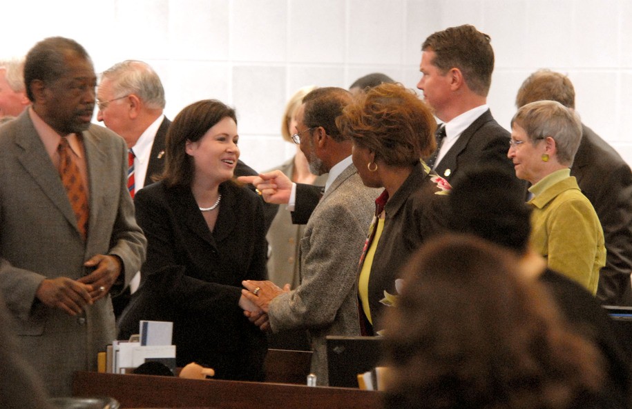 Newly sworn-in Rep. Tricia Cotham, second left, is greeted by fellow legislators as she takes her seat for the start of the House session, Thursday, March 22, 2007, in Raleigh, N.C. (AP Photo/The Charlotte Observer, Karen Tam)