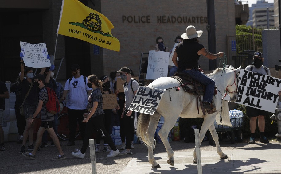 Samuel Greyhorse rides his horse Tex past other demonstrators in Austin, Texas, Thursday, June 4, 2020, to protest the death of George Floyd, a black man who died in police custody in Minneapolis on Memorial Day. (AP Photo/Eric Gay)