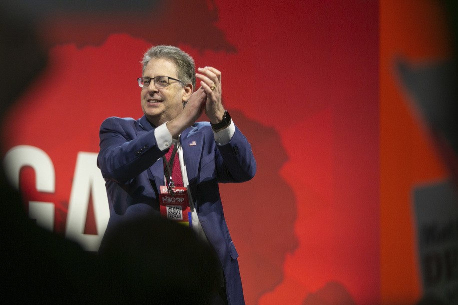 Matthew DePerno who is running for the Republican Attorney General nomination applauds as he takes the stage during the Michigan Republican convention at Devos Place in Grand Rapids, Mich., on Saturday, April 23, 2022. (Daniel Shular/The Grand Rapids Press via AP)