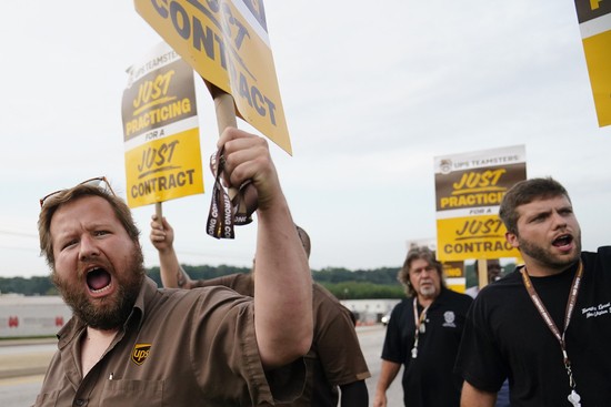 UPS teamsters and workers hold a rally, Friday, July 21, 2023, in Atlanta, as a national strike deadline nears. The Teamsters said Friday that they will resume contract negotiations with UPS, marking an end to a stalemate that began two weeks ago when both sides walked away from talks while blaming each other. (Uploaded by Associated Press. AP Photo/Brynn Anderson)