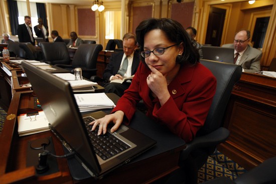 Delegate Jennifer L. McClellan, D-Richmond, looks over items on her computer at her desk in the House chamber during a recess in the floor session of the House of Delegates in Richmond, Va., Thursday, March 13, 2008. (AP Photo/Richmond Times-Dispatch, Bob Brown)