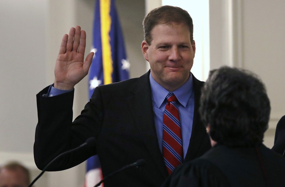 New Hampshire Gov. Chris Sununu raises his hand as he is sworn in at the State House in Concord, N.H., Thursday, Jan. 5, 2017. Sununu, the first Republican to hold the corner office in a dozen years, follows in the footsteps of his father, former N.H. Governor John H. Sununu. (AP Photo/Charles Krupa)