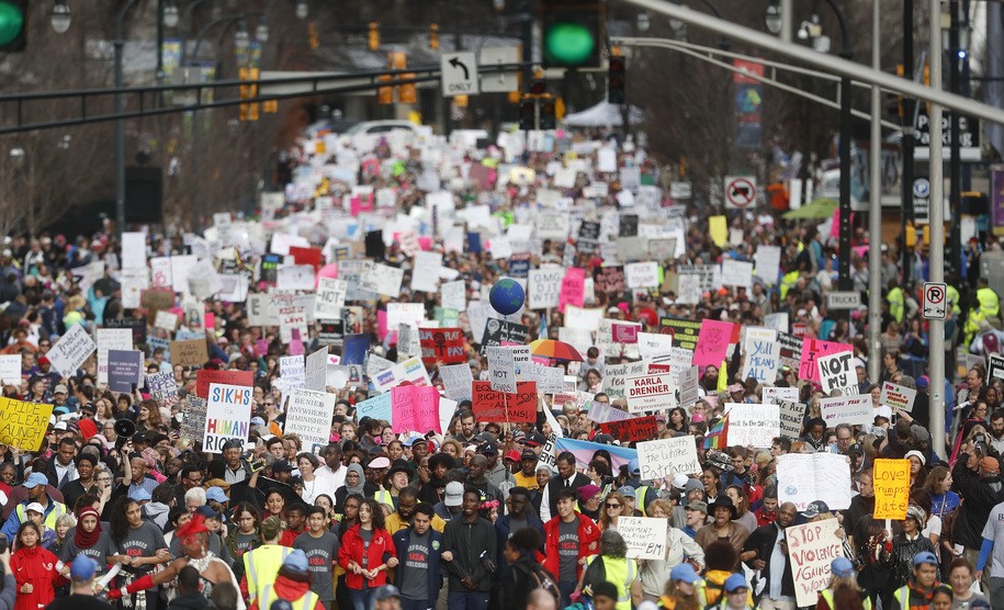 Demonstrators march Saturday, Jan. 21, 2017, in Atlanta. Thousands of people marched through Atlanta one day after President Donald Trump's inauguration. (AP Photo/John Bazemore)