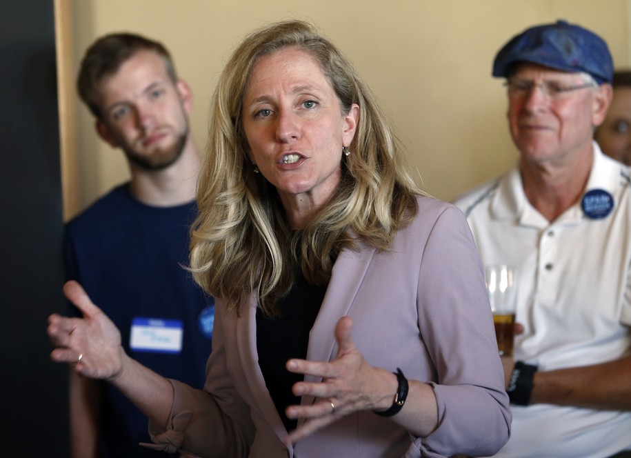 Former CIA officer and Democratic candidate for the 7th district Congressional seat, Abigail Spanberger, center, speaks to supporters at a rally in Richmond, Va., Wednesday, July 18, 2018.  Opposition to President Donald Trump is changing the political map for Democrats who find themselves riding a wave of anti-Trump energy to compete in areas they once left for lost.  (AP Photo/Steve Helber)