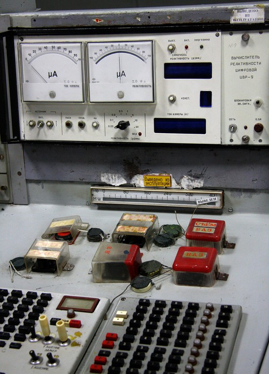 Close-up of reactor control instrumentation in Unit 1, Chernobyl Nuclear Power Plant.   The six buttons on the panel are scram switches, including the AZ-5 button that led to destruction in Unit 4.  Above these switches is a TsVR-9 Digital Reactivity Calculator, which reads signals from the reactor's ionization chambers and calculates reactivity based on a point kinetics model.  The Soviets did not use the dollar ($) as a unit of reactivity because of overtones of capitalist imperialism; instead, instruments like this display units of beta_effective (which are the same as dollars).