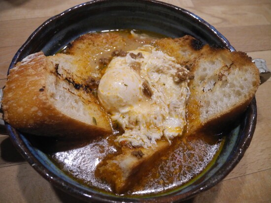 Sopa de Ajo - garlic soup - after a recipe in Moro, the Cookbook. Sliced grilled bread in a pottery soup bowl, with garlic spoured over, and topped with an egg poached in the soup.