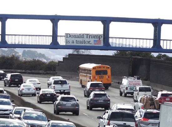 Donald Trump is a Traitor sign with Flag over US 101.