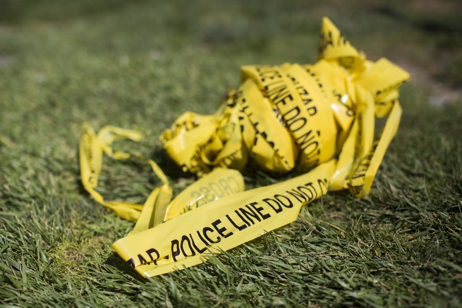 A bundle of police crime scene tape is left on front of the 7-eleven shop in Santa Ana, California on August 08, 2019 where a security guard was fatally stabbed. - Police said the suspect, Zachary Castaneda, a 33-year-old resident of Garden Grove used multiple knives or machetes in the attacks that started yesterday afternoon. (Photo by Apu Gomes / AFP) (Photo by APU GOMES/AFP via Getty Images)