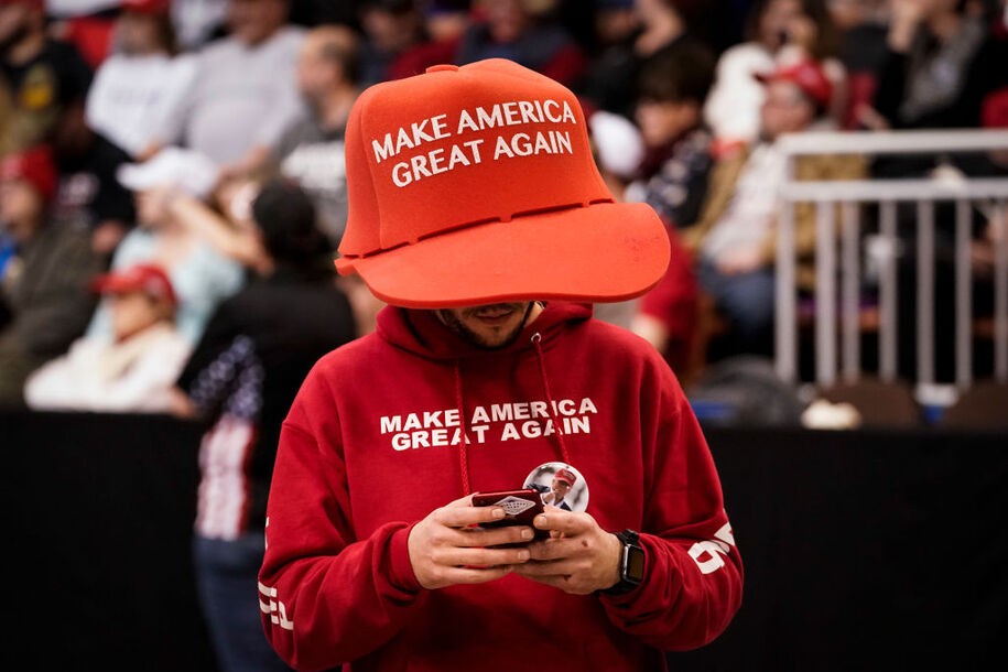 MANCHESTER, NH - FEBRUARY 10: A supporter of U.S. President Donald Trump wears an oversize 'Make America Great Again Hat' as he waits for the start of a 'Keep America Great' rally at Southern New Hampshire University Arena on February 10, 2020 in Manchester, New Hampshire. New Hampshire will hold its first in the national primary on Tuesday. (Photo by Drew Angerer/Getty Images)