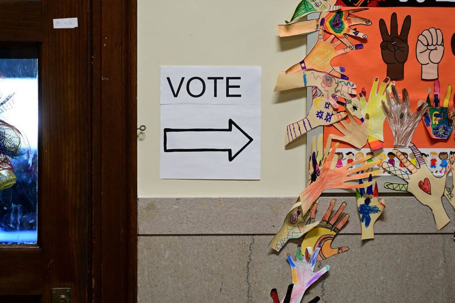 PHILADELPHIA, PA - NOVEMBER 08:  A sign stating 'VOTE' is affixed to the wall beside children's art work of hand drawings at the Shawmont School polling location on November 8, 2022 in Philadelphia, Pennsylvania. After months of candidates campaigning, Americans are voting in the midterm elections to decide close races across the nation. (Photo by Mark Makela/Getty Images)