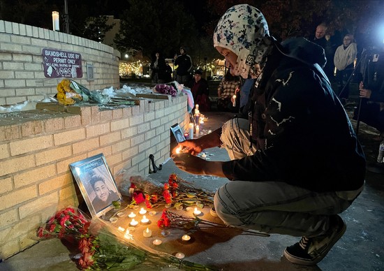 A friend of victim Raymond Green Vance lights candles in front of his portrait during a vigil for the victims of a mass shooting at Club Q, an LGBTQ nightclub, at Acacia Park in Colorado Springs, Colorado, on November 21, 2022. - Anderson Lee Aldrich, 22, was arrested following the November 19 shooting at Club Q in Colorado Springs that left five people dead and at least 18 injured, officials said. (Photo by Cecilia SANCHEZ / AFP) (Photo by CECILIA SANCHEZ/AFP via Getty Images)
