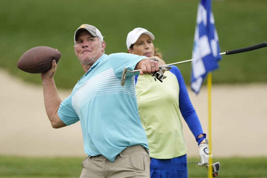 MADISON, WISCONSIN - JUNE 11: Former NFL player Brett Favre throws a football to a fan on the 14th green during the Celebrity Foursome at the second round of the American Family Insurance Championship at University Ridge Golf Club on June 11, 2022 in Madison, Wisconsin. (Photo by Patrick McDermott/Getty Images)