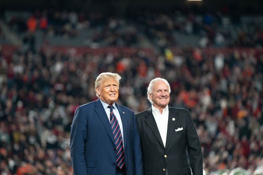 COLUMBIA, SOUTH CAROLINA - NOVEMBER 25: (L-R) Former U.S. President Donald Trump joins South Carolina Gov. Henry McMaster on the field during halftime in the Palmetto Bowl between Clemson and South Carolina at Williams Brice Stadium on November 25, 2023 in Columbia, South Carolina. Trump attended the rivalry game in a key early-voting state as he campaigns ahead of next yearâ€™s Republican presidential primary. (Photo by Sean Rayford/Getty Images)