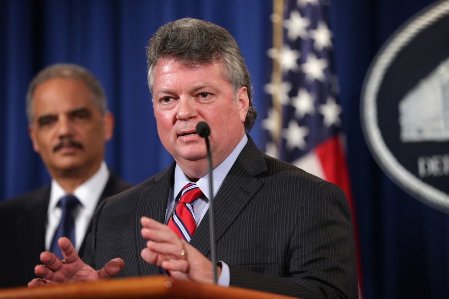 WASHINGTON, DC - FEBRUARY 03:  Mississippi Attorney General Jim Hood (R) speaks as U.S. Attorney General Eric Holder (L) looks on during a news conference to make a major financial fraud announcement February 3, 2015 at the Justice Department in Washington, DC. Rating agency S&P has agreed to pay a $1.37 billion fine to settle charges from the Justice Department and 19 state attorneys general and the District of Columbia 'to resolve allegations that S&P had engaged in a scheme to defraud investors in structured financial products known as Residential Mortgage-Backed Securities (RMBS) and Collateralized Debt Obligations (CDOs).'  (Photo by Alex Wong/Getty Images)