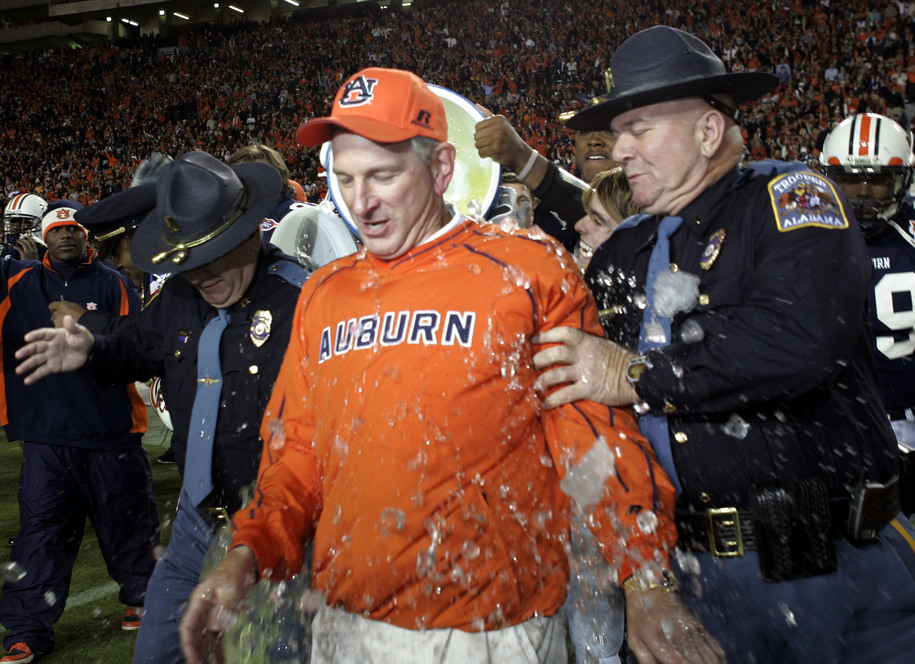 AUBURN, AL - NOVEMBER 19:  Head Coach Tommy Tuberville of Auburn University tries to avoid a bucket of water while celebrating their win over the University of Alabama on November 19, 2005 at Jordan-Hare Stadium in Auburn, Alabama.  Auburn defeated Alabama 28-18.   (Photo by Chris Graythen/Getty Images)