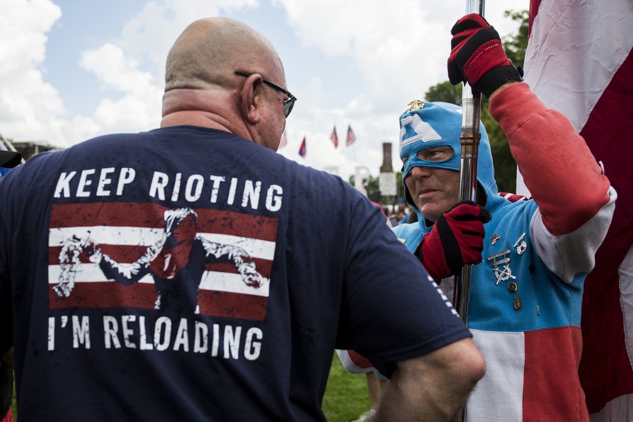 A man dressed as Captain America speaks to a demonstrator during the pro-Trump 'Mother of All Rallies' held on the National Mall in Washington, DC on September 16, 2017..Supporters of President Donald Trump gathered in the US capital to show support of 'free-speech' dubbed the Mother of All Rallies. / AFP PHOTO / ZACH GIBSON        (Photo credit should read ZACH GIBSON/AFP via Getty Images)
