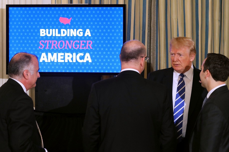 WASHINGTON, DC - FEBRUARY 12:  U.S. President Donald Trump (2nd R) talks with (L-R) Miami-Dade County Chairman Esteban Bovo, Wichita Mayor Jeff Longwell and Assistant to the President Reed Cordish at the conclusion of a meeting to unveil his administration's long-awaited infrastructure plan in the State Dining Room at the White House February 12, 2018 in Washington, DC. The $1.5 trillion plan to repair and rebuild the nation's crumbling highways, bridges, railroads, airports, seaports and water systems is funded with $200 million in federal money with the remaining 80 percent coming from state and local governments.  (Photo by Chip Somodevilla/Getty Images)