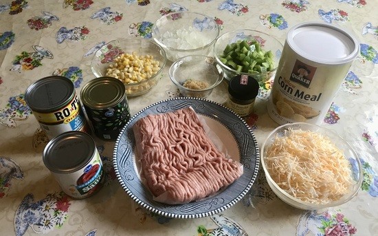 Tamale pie ingredients (clockwise from L): tomato sauce, diced tomatoes, olives, corn, onion, garlic, green pepper, chili powder, cornmeal, cheese, ground turkey