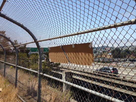 back of impeach sign on fence next to 280 flyaway ramp