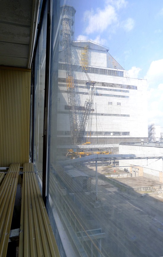 Unit 3 reactor building at Chernobyl visible from the deaerator corridor looking west in 2011.  In 2015, the iconic striped ventilation chimney visible here between Reactors 3 and 4 has been removed to make way for the New Safe Confinement.