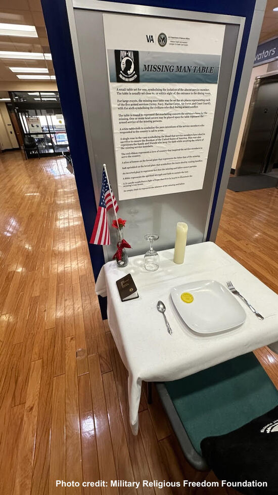 POW MIA table with Gideon New Testament on it