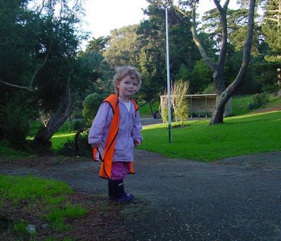 Little girl in highway safety vest.