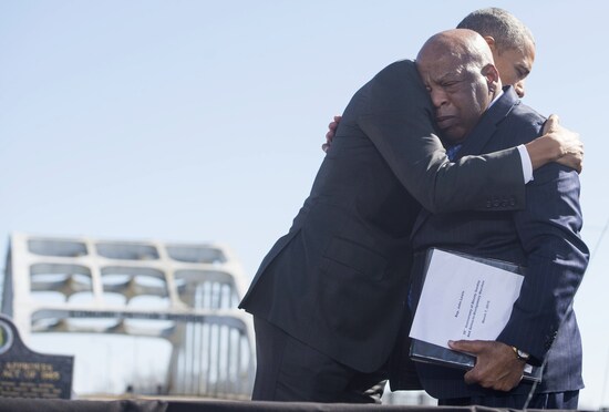 US President Barack Obama (R) hugs US Representative John Lewis, Democrat of Georgia, one of the original marchers at Selma, during an event marking the 50th Anniversary of the Selma to Montgomery civil rights marches at the Edmund Pettus Bridge in Selma, Alabama, March 7, 2015. The Obamas traveled to Selma to commemorate Bloody Sunday, when civil rights marchers attempting to walk to the Alabama capital of Montgomery to end voting discrimination against African Americans, clashed with police on the Edmund Pettus Bridge. AFP PHOTO / SAUL LOEB        (Photo credit should read SAUL LOEB/AFP via Getty Images)