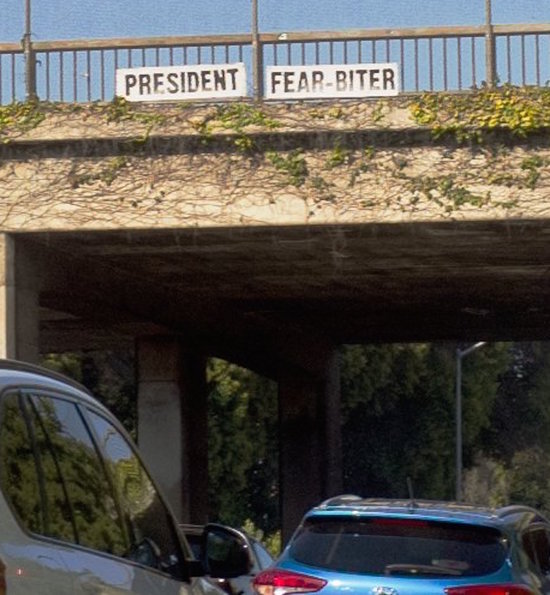 President Fear Biter sign over LA freeway.