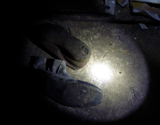 Shoes abandoned in the basement of the Pripyat hospital after the Chernobyl accident contain pieces of reactor debris melted into the soles.  These shoes measure about 0.3 roentgen per hour on contact (gamma exposure rate only).