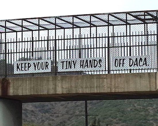 Keep Your Tiny Hands Off DACA sign over Interstate 5.