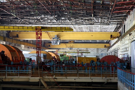 Turbine hall in the Chernobyl Nuclear Power Plant, looking west.  Note the white beams in the roof; this is where the roof collapsed following a fire in 1991 that permanently crippled Unit 2. 