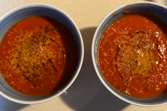 two bowls of rich red tomato soup